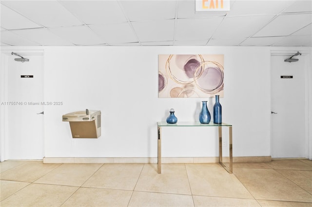 401 Golden Isles Dr Unit 516, Hallandale Beach, FL 33009 - hallway with tile patterned flooring and a drop ceiling