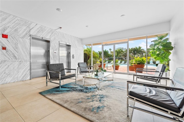 401 Golden Isles Dr Unit 516, Hallandale Beach, FL 33009 - tiled living room featuring elevator and plenty of natural light