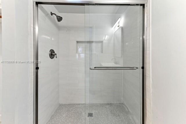 full bath with a shower stall