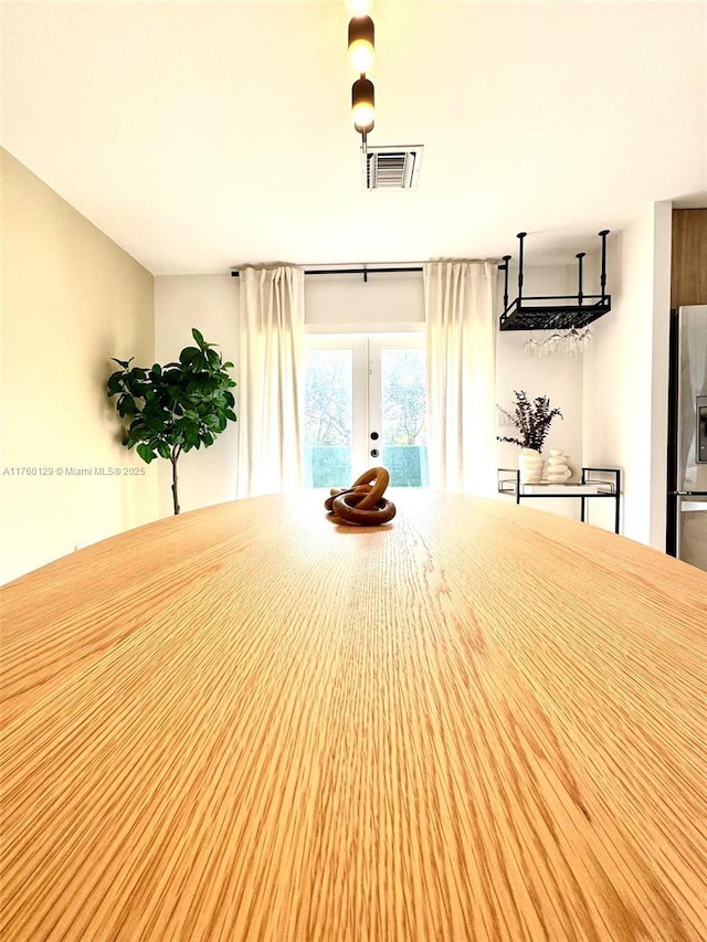 interior space with visible vents and french doors