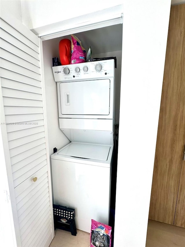 clothes washing area featuring laundry area and stacked washer and clothes dryer