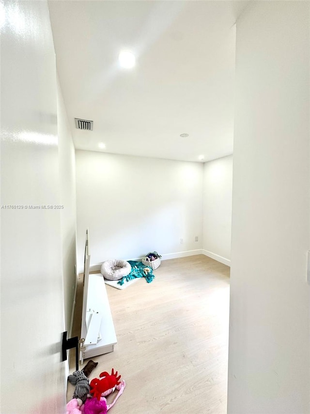 interior space featuring visible vents, recessed lighting, baseboards, and wood finished floors
