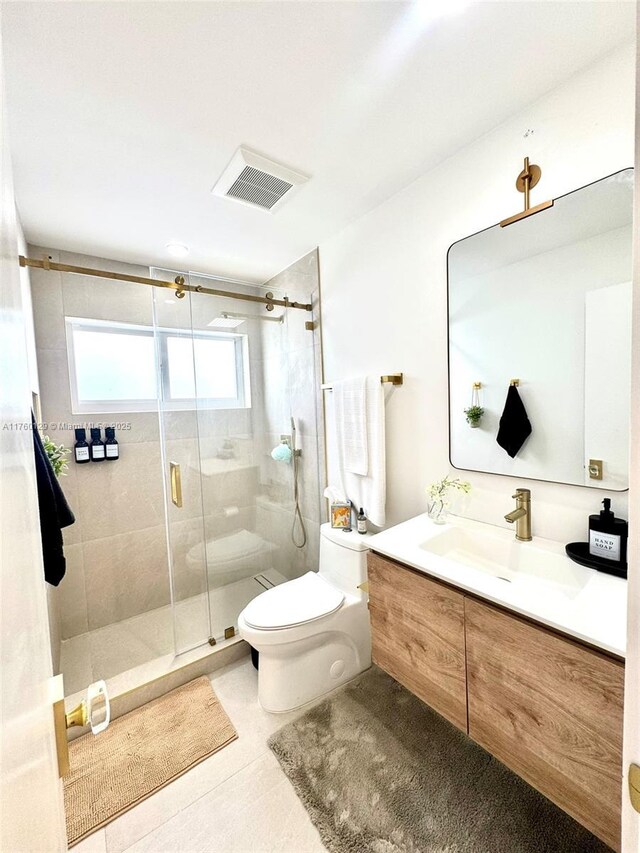 bathroom featuring visible vents, toilet, a shower stall, and vanity