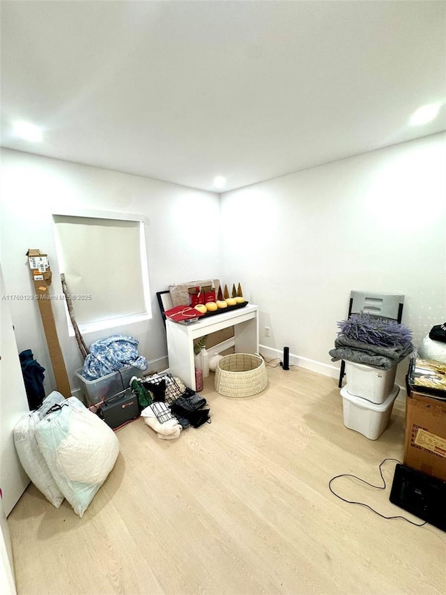interior space with baseboards and wood finished floors