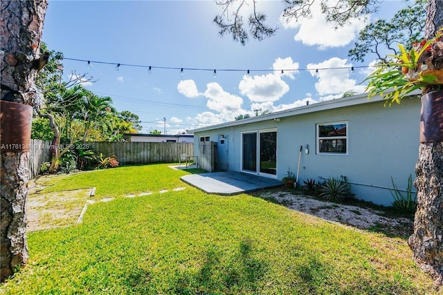 view of yard with a patio and a fenced backyard