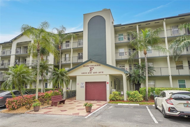 view of building exterior featuring uncovered parking