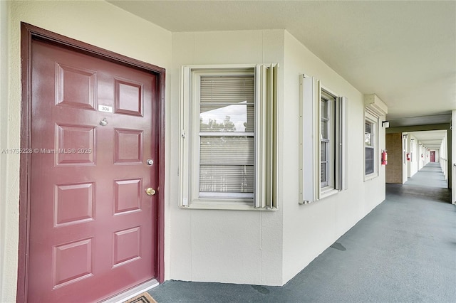 view of exterior entry with stucco siding