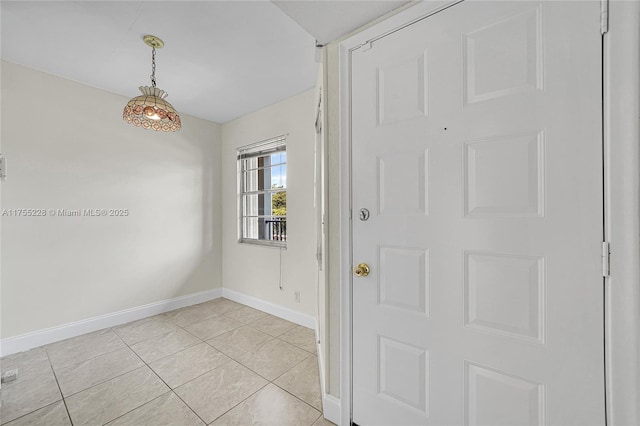 foyer with light tile patterned floors and baseboards