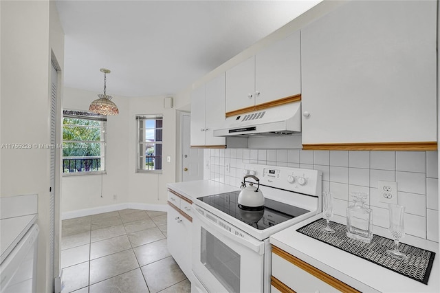 kitchen featuring backsplash, white range with electric cooktop, under cabinet range hood, light countertops, and white cabinetry