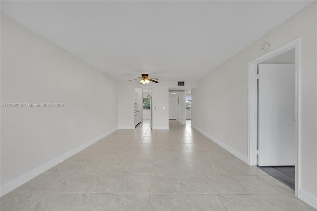 unfurnished room featuring visible vents, baseboards, and a ceiling fan