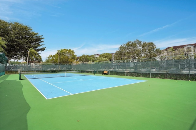 view of tennis court with fence