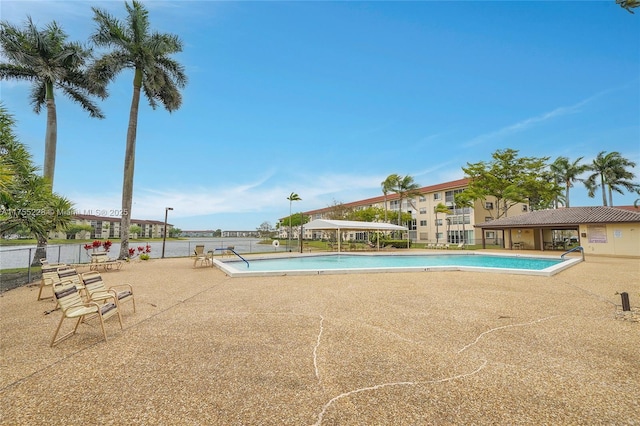 community pool featuring a patio area and fence