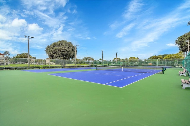 view of sport court featuring fence