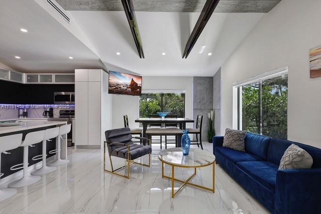 living room with recessed lighting, visible vents, and a wealth of natural light