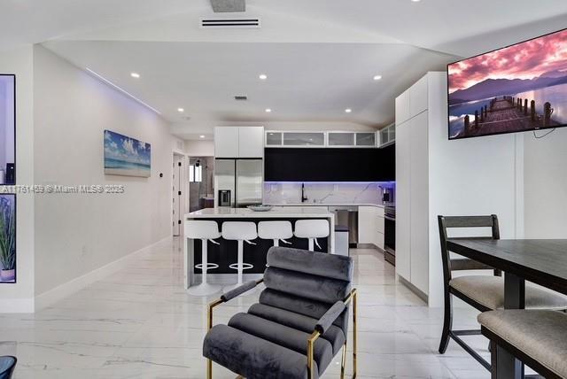 dining space featuring recessed lighting, marble finish floor, visible vents, and baseboards