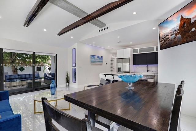 dining room with visible vents, marble finish floor, lofted ceiling with beams, recessed lighting, and baseboards