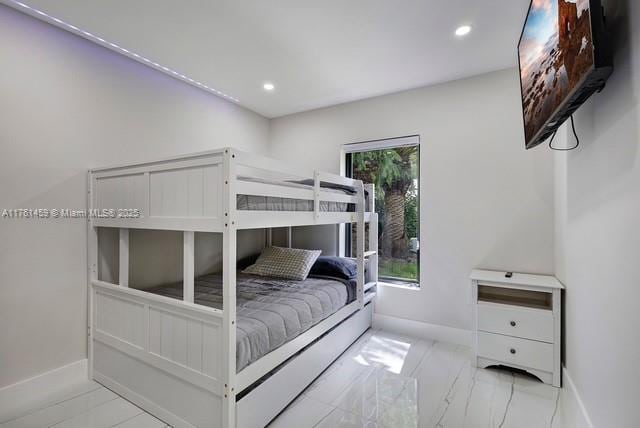 bedroom featuring recessed lighting, baseboards, and marble finish floor