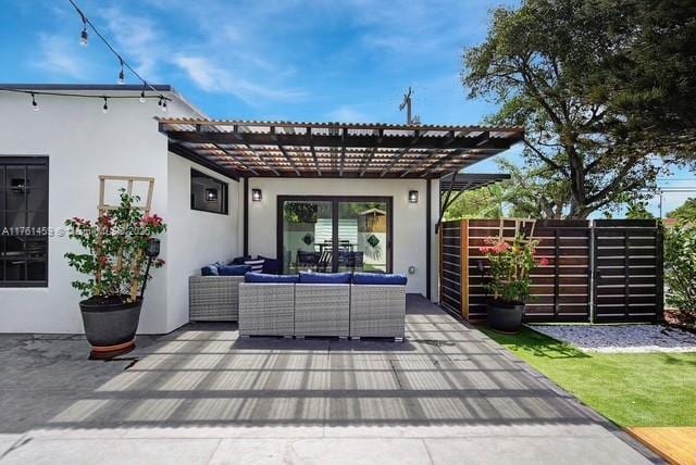 view of patio featuring an outdoor hangout area, a pergola, and fence