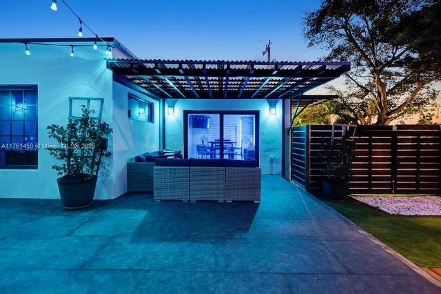 view of patio / terrace with an outdoor hangout area, a pergola, and fence