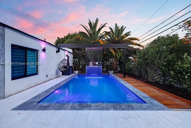 outdoor pool with a patio area