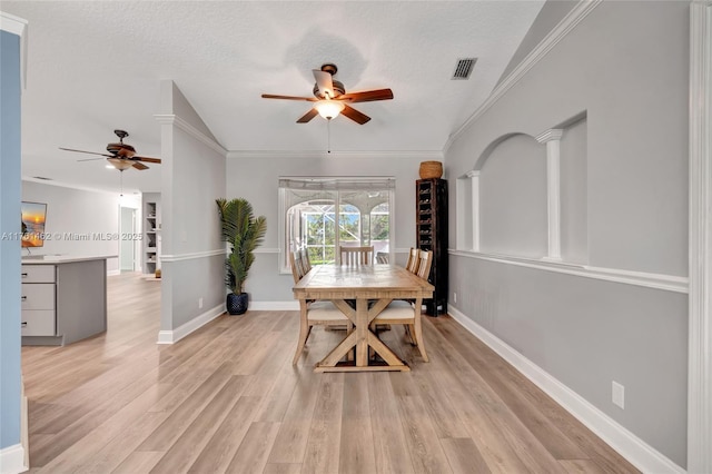 dining room with light wood-type flooring, visible vents, baseboards, and a textured ceiling