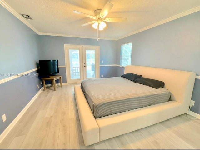 bedroom with visible vents, crown molding, baseboards, french doors, and wood finished floors