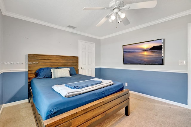 carpeted bedroom featuring visible vents, a ceiling fan, crown molding, and baseboards