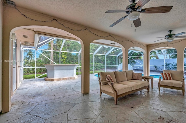 unfurnished sunroom with ceiling fan