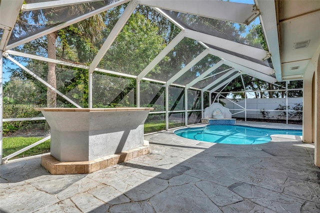 view of swimming pool featuring glass enclosure, a patio, a fenced in pool, and fence