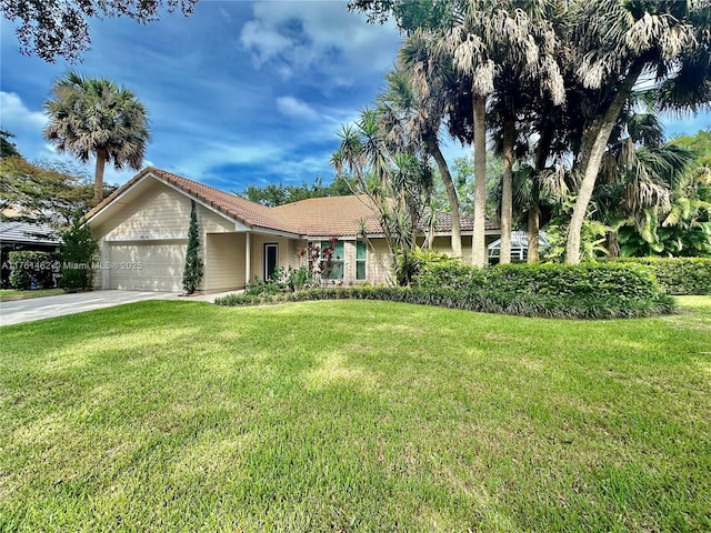 ranch-style home with driveway, a front lawn, an attached garage, and a tile roof