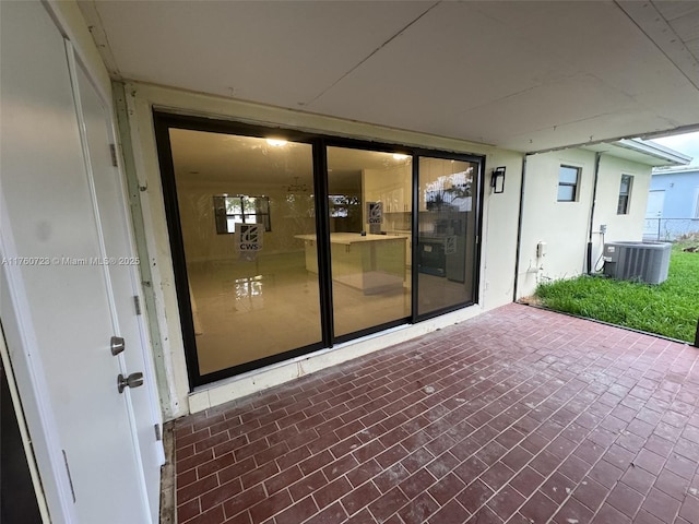 exterior space with cooling unit and brick siding