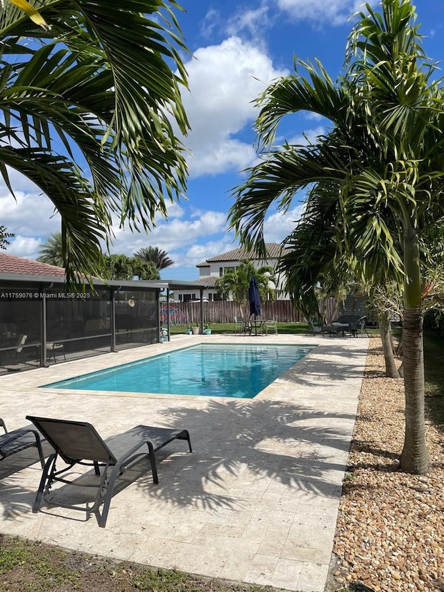 view of swimming pool with a patio, fence, and a fenced in pool