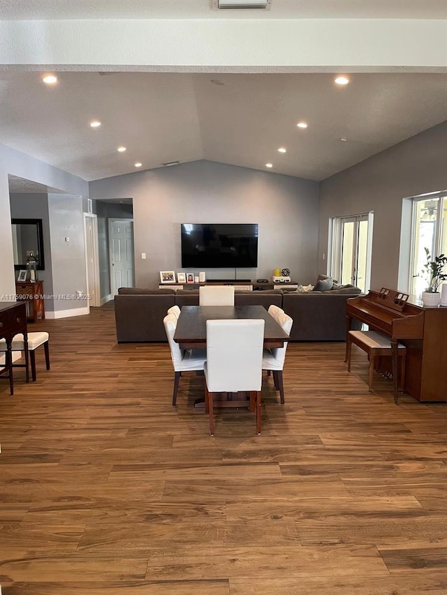 dining room featuring lofted ceiling, recessed lighting, wood finished floors, and baseboards