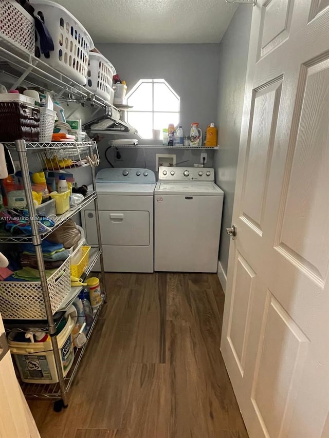 laundry area with dark wood-style floors, laundry area, a textured ceiling, and separate washer and dryer