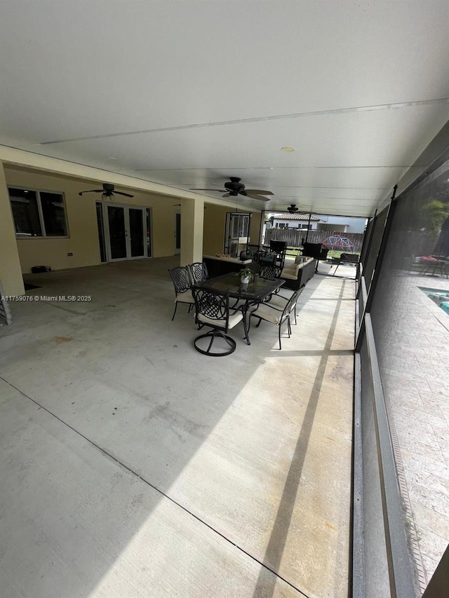 sunroom / solarium with a ceiling fan