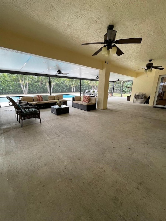 view of patio with ceiling fan, a lanai, an outdoor pool, and an outdoor hangout area