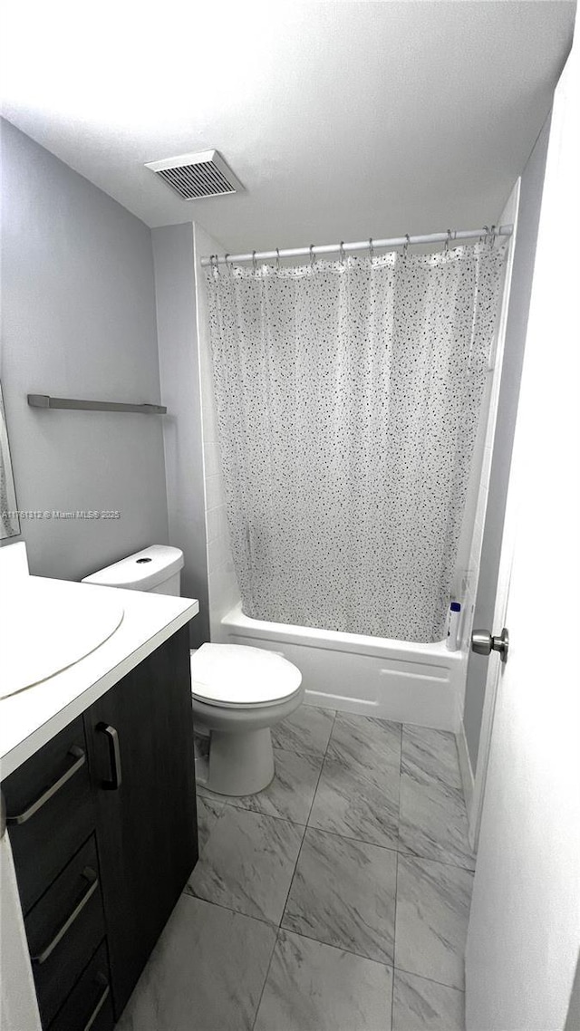 bathroom featuring visible vents, toilet, marble finish floor, shower / tub combo with curtain, and vanity