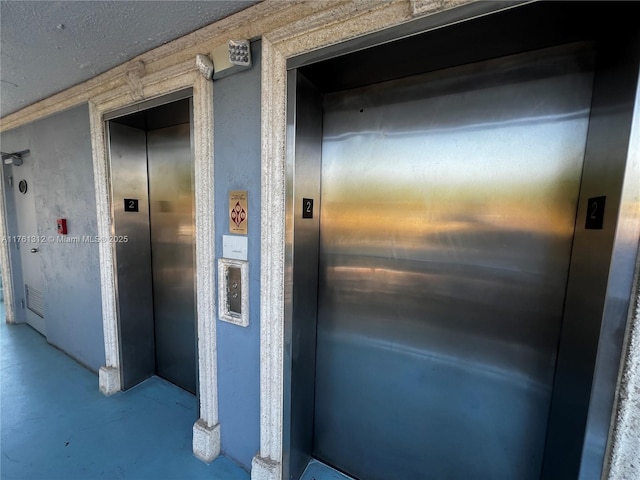 exterior space featuring stucco siding and elevator