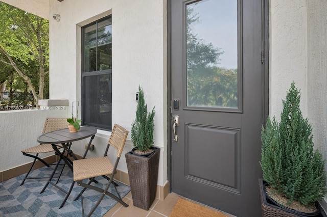 property entrance with stucco siding