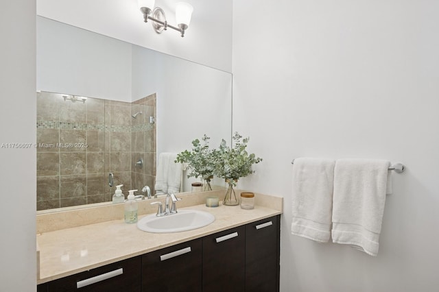 full bathroom with vanity and a tile shower