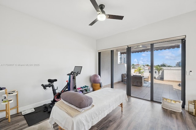 bedroom with ceiling fan, baseboards, wood finished floors, and access to outside