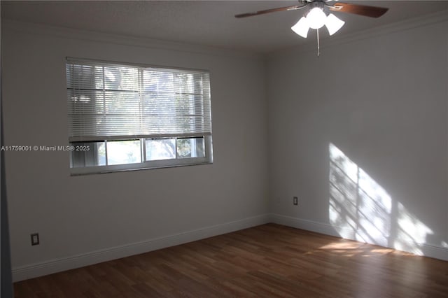 empty room featuring ceiling fan, wood finished floors, baseboards, and ornamental molding