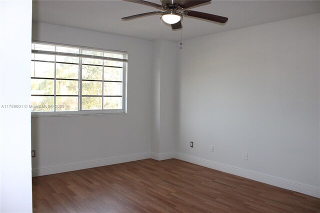 unfurnished room featuring wood finished floors, baseboards, and ceiling fan
