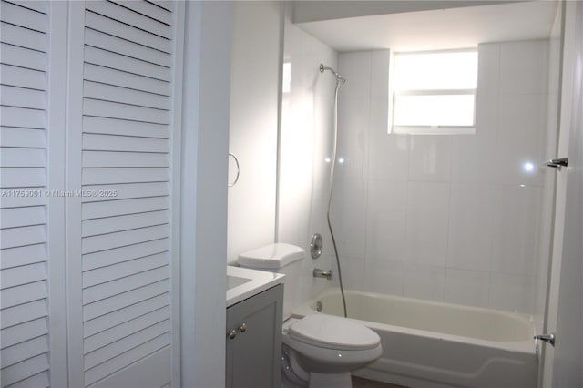 bathroom featuring toilet, tub / shower combination, and vanity