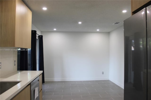 kitchen featuring visible vents, baseboards, dishwasher, recessed lighting, and refrigerator