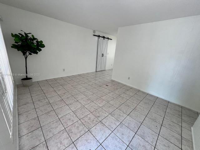 spare room featuring a barn door