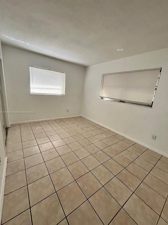 spare room with baseboards