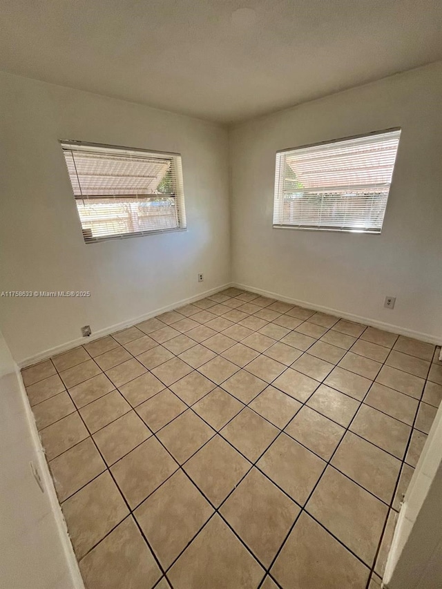 unfurnished room featuring baseboards