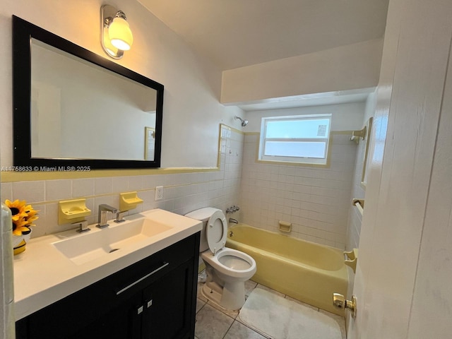 bathroom with tile walls, toilet, shower / tub combination, tile patterned floors, and vanity