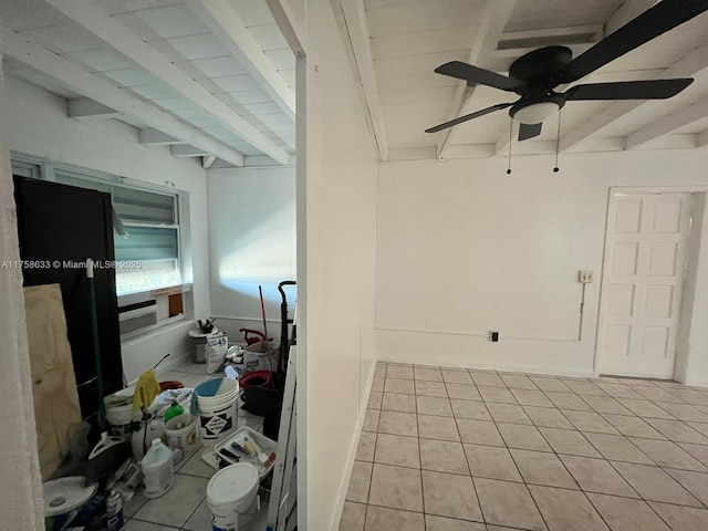 interior space featuring beam ceiling, tile patterned flooring, and ceiling fan